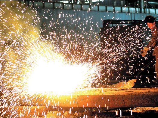 A worker oversees production at a plant