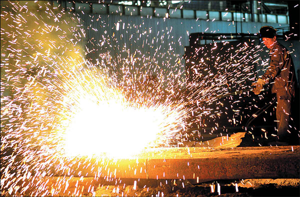 A worker oversees production at a plant