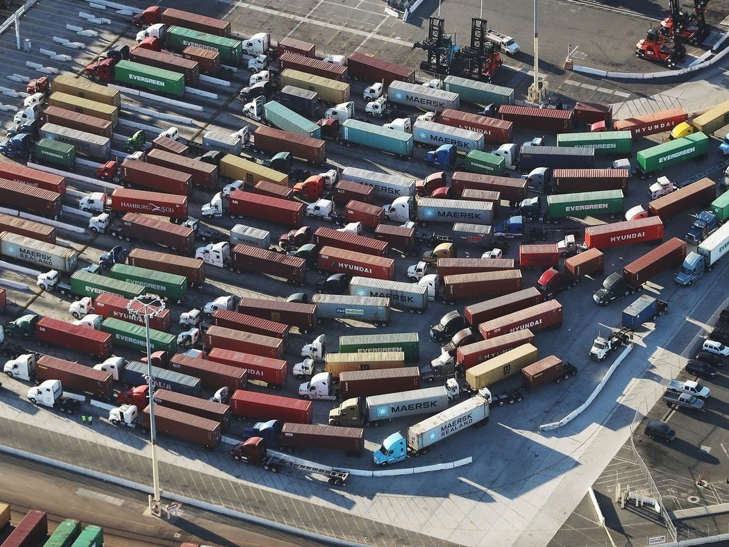 Trucks with shipping containers at the Port of Los Angeles Trucks with shipping containers at the Port of Los Angeles