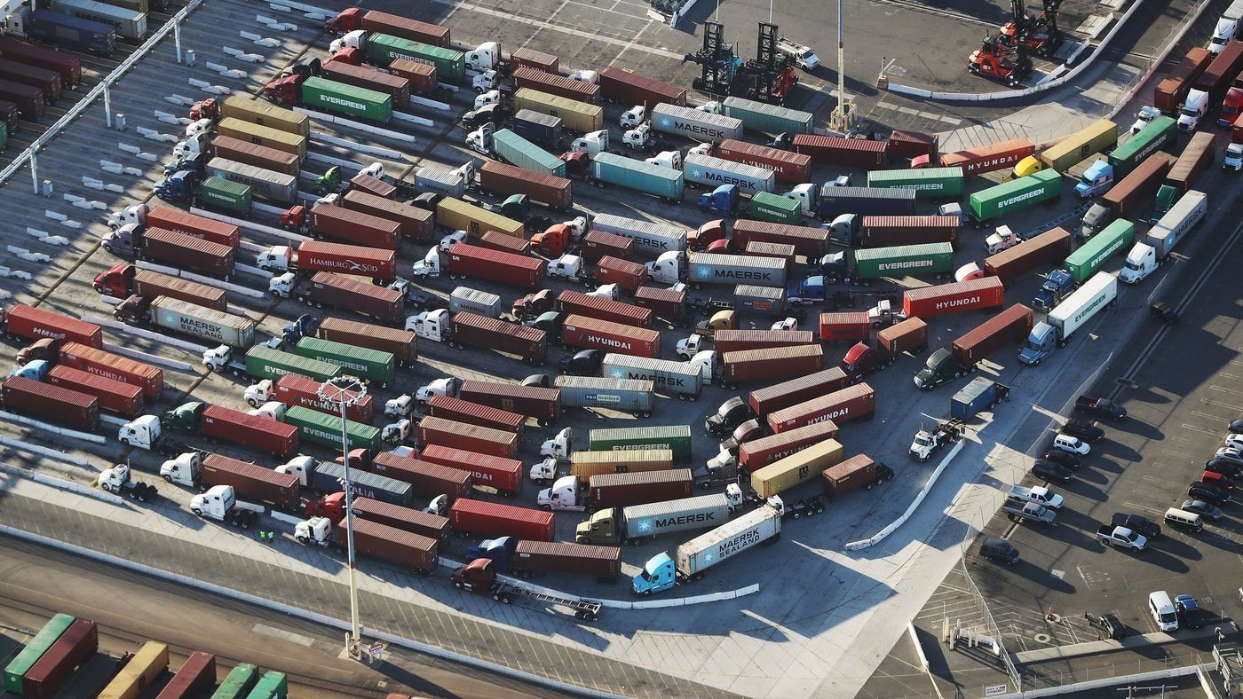 Trucks with shipping containers at the Port of Los Angeles Trucks with shipping containers at the Port of Los Angeles
