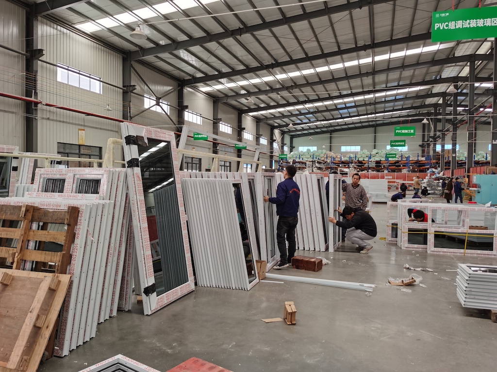 The worker is testing the finished aluminum doors