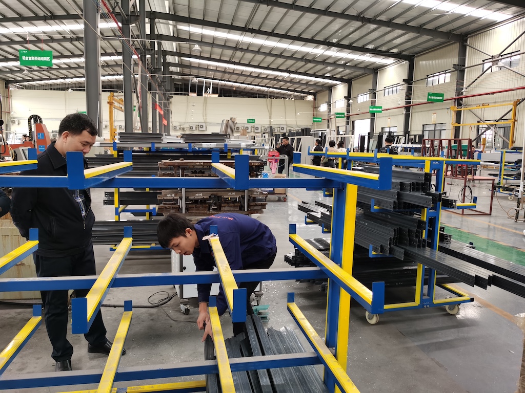 The workers are making parts of the aluminum windows The workers are making parts of the aluminum windows